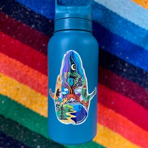 May include: A teal blue water bottle with a colorful sticker of a tree with a moon and stars in the background. The sticker has the text "Abstract Nature" at the bottom.