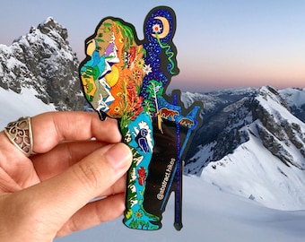 May include: A colorful sticker of a hiker with a backpack, mountains, trees, and stars. The sticker is on a black background with the text "@abstract.hikes" in white.