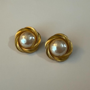Pair of clip-on gold tone and faux pearl earrings.