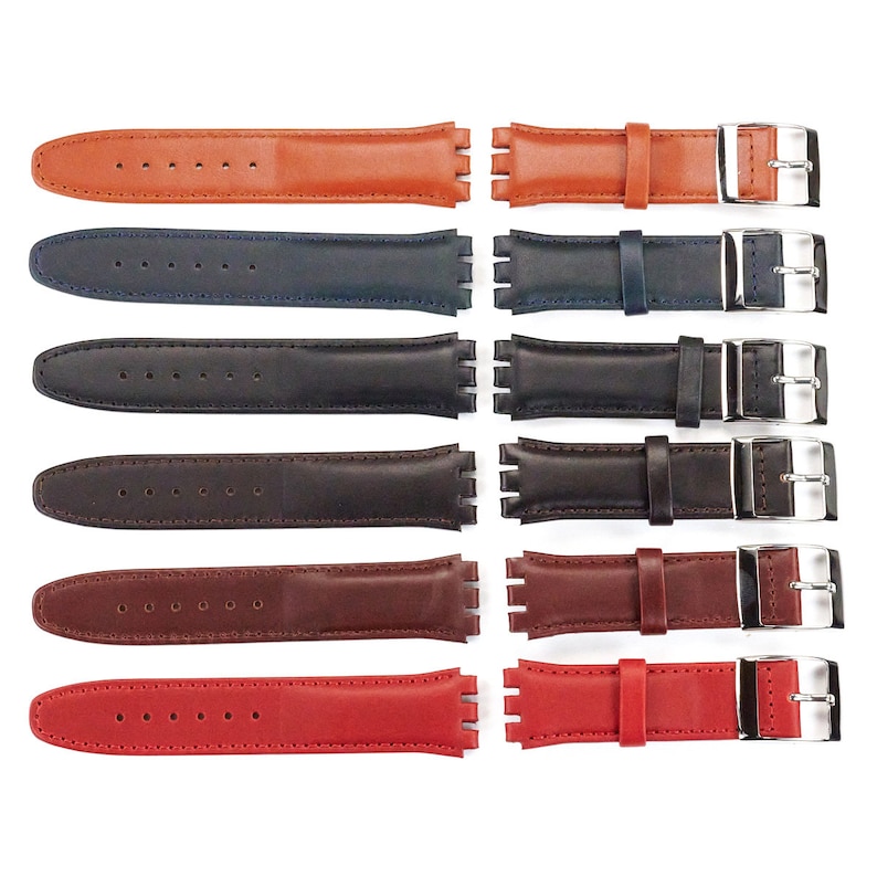 K&ouml;nnte beinhalten: Sechs verschiedene farbige Uhrenarmb&auml;nder, jedes mit einer silbernen Schlie&szlig;e. Die Armb&auml;nder sind aus Leder und in Braun, Schwarz, Rot und Braun erh&auml;ltlich.