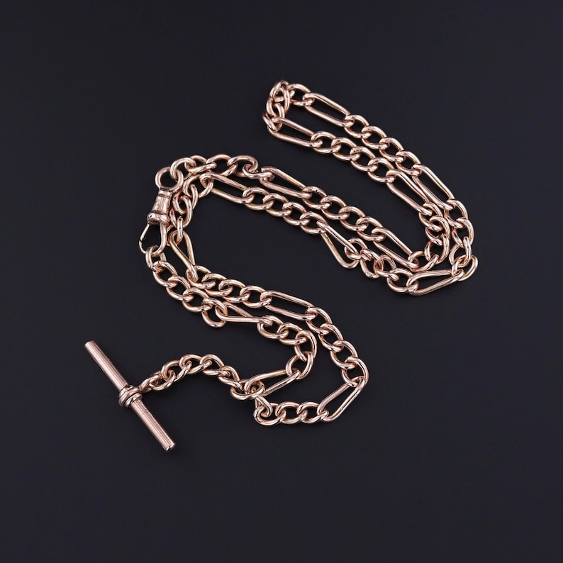 An antique gold watch chain from the early 1900s.  The chain is 17 inches long with a T bar and additional 1 inch drop.  It is stylish and perfect for any jewelry lover.