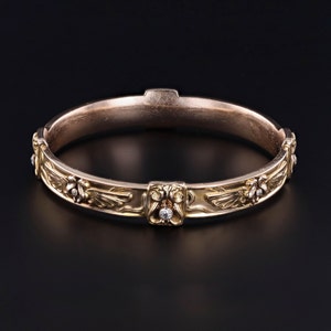 A side profile of our 14k gold Art Nouveau era Egyptian Revival diamond bangle in the style of Riker Brothers.