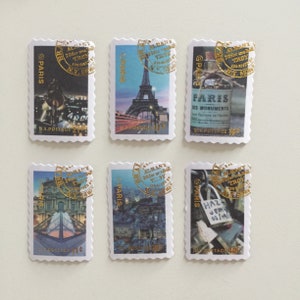 May include: Six postage stamps featuring images of Paris, France. Each stamp has a gold circular stamp with the text "ALBANY 20 for one roll TLDY NY 12205" and "@PARIS" printed on the stamp. The stamps feature images of the Eiffel Tower, a bridge, a building with a glass pyramid, a street scene, and a padlock on a bridge.
