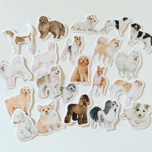 May include: A set of 17 illustrated dog stickers featuring various breeds in different poses. The stickers are printed on white paper and have a glossy finish.