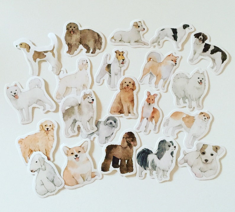 May include: A set of 17 illustrated dog stickers featuring various breeds in different poses. The stickers are printed on white paper and have a glossy finish.