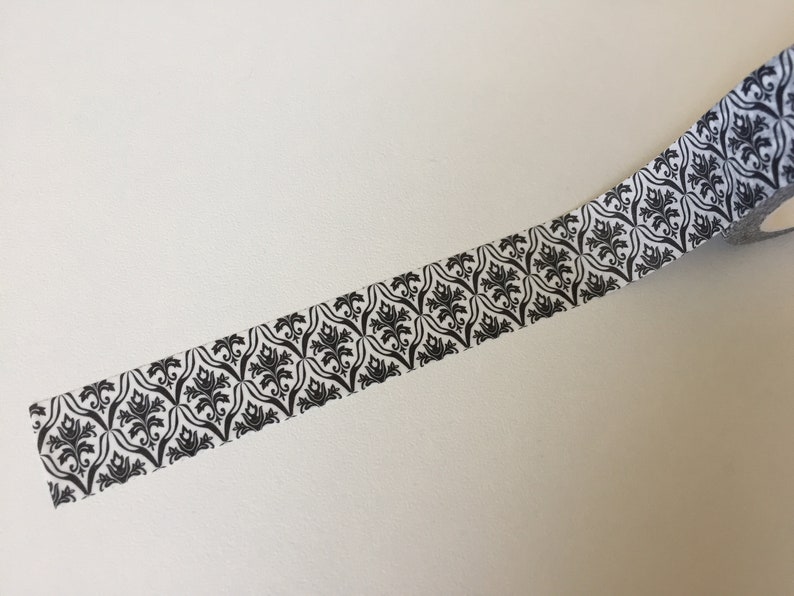 May include: Black and white patterned washi tape with a damask design.