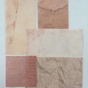 May include: Four different textured paper samples in various shades of brown and beige. The samples are arranged in a grid pattern.