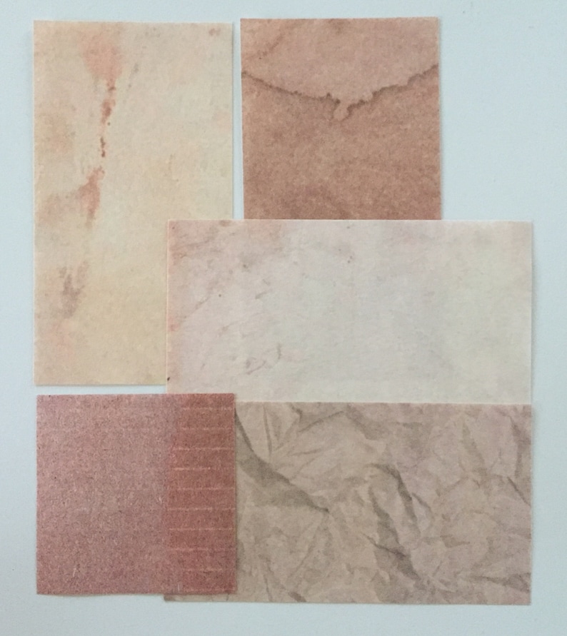 May include: Four different textured paper samples in various shades of brown and beige. The samples are arranged in a grid pattern.