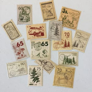 May include: A collection of vintage-style stamps with various designs, including a lighthouse, a van, a mountain, a fern, a castle, and trees. The stamps are printed on beige paper with red and brown ink and have a scalloped edge.