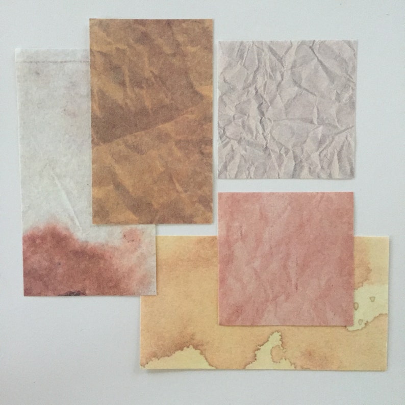 May include: Five different textured paper squares in various shades of brown, beige, and pink. The squares are arranged in a staggered pattern on a white background.