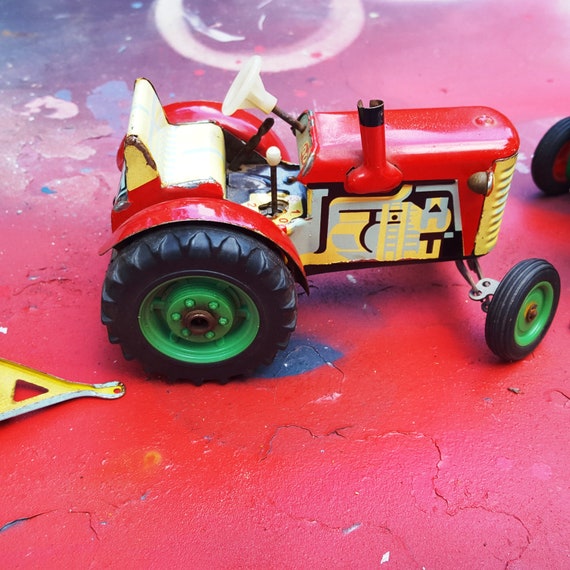 red metal tractor toy