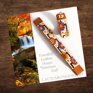 May include: A pair of beaded bracelets with leather hoops. The bracelets are made with colorful beads in a geometric pattern. The text "Foresthill Leather Hoops "Summers End" CACTUSROSEJEWELRY" is printed on the card.