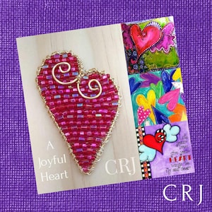 May include: A pink beaded heart with gold wire accents, surrounded by colorful hearts and the text "A Joyful Heart" and "CRJ".