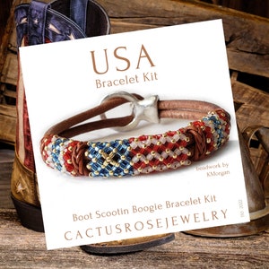 May include: USA Bracelet Kit, a beaded leather bracelet with red, white, and blue beads in a pattern resembling the American flag. The bracelet is on a white background with the text "USA Bracelet Kit" and "Boot Scootin Boogie Bracelet Kit" in brown text. The text "Cactusrosejewelry" is in brown text with a cactus flower design. The text "beadwork by K.Morgan" is in black text.