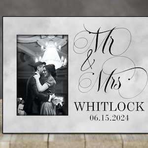 May include: A white picture frame with a black border and a photo of a couple dancing. The frame has the text "Mr & Mrs Whitlock 06.15.2024" printed on it.