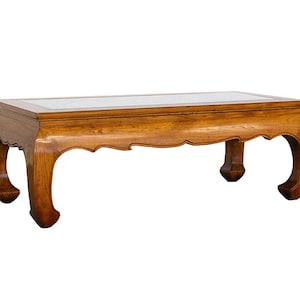 May include: A wooden coffee table with a rectangular top and four curved legs. The table has a light brown finish and a white marble top.