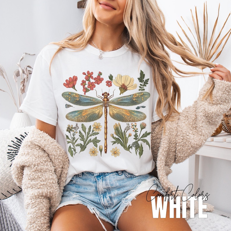 This Women's Dragonfly Floral T-Shirt is a boho and nature-inspired tee that is perfect for garden lovers and those who embrace the cottagecore aesthetic. It exudes a peaceful and whimsical vibe, making it a great addition to a nature lover's wardrobe. Ideal for casual wear or as a thoughtful gift for a loved one who enjoys botanical designs. Relevant for Earth Day, birthdays, and any nature-themed celebrations.