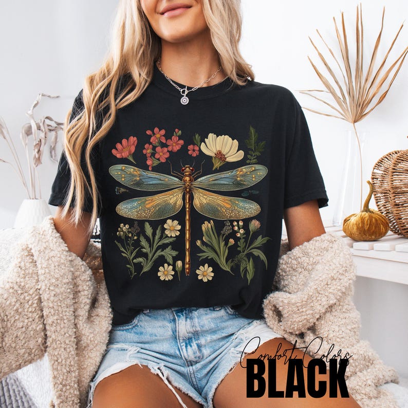 This Women's Dragonfly Floral T-Shirt is a boho and nature-inspired tee that is perfect for garden lovers and those who embrace the cottagecore aesthetic. It exudes a peaceful and whimsical vibe, making it a great addition to a nature lover's wardrobe. Ideal for casual wear or as a thoughtful gift for a loved one who enjoys botanical designs. Relevant for Earth Day, birthdays, and any nature-themed celebrations.