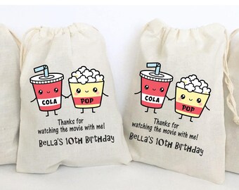 May include: White cotton drawstring bags with a cartoon image of a cup of cola and a bucket of popcorn with the text "Thanks for watching the movie with me! Bella's 10th Birthday"