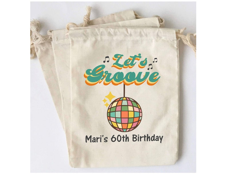 May include: A set of three white cotton drawstring bags with a retro design featuring a disco ball, musical notes, and the text "Let's Groove" in a colorful font. The bags also include the text "Mari's 60th Birthday".