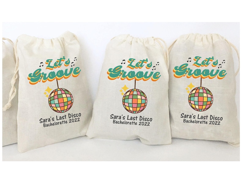 May include: Three white fabric bags with a drawstring closure. Each bag has a colorful disco ball graphic and the text "Let's Groove" in a retro font. The text "Sara's Last Disco Bachelorette 2022" is printed below the graphic.
