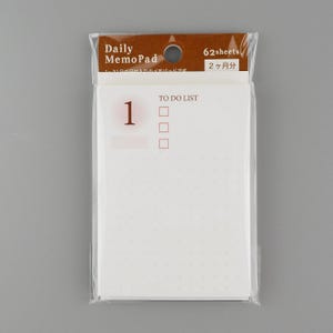 May include: A white memo pad with a brown header that says "Daily MemoPad" and "62 sheets". The memo pad has a to-do list section with a number "1" and four checkboxes.