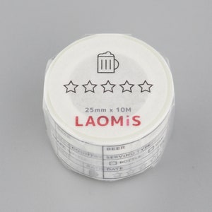 May include: White washi tape roll with a beer mug icon and five stars. The text "25mm x 10M LAOMi'S" is printed on the roll. The tape has a grid pattern with the words "BEER" and "SERVING TYPE" printed on it.