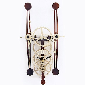 May include: A wooden wall clock with a unique design featuring intricate gears and a pendulum. The clock face is white with black hands and Roman numerals.