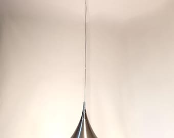 May include: A contemporary pendant light with a brushed metal finish. The light features a conical shade and a frosted glass disc. It is suspended from the ceiling by a thin wire.