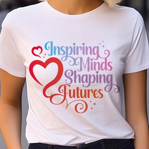 May include: White t-shirt with a rainbow-colored graphic that says "Inspiring Minds Shaping Futures" with a red heart.