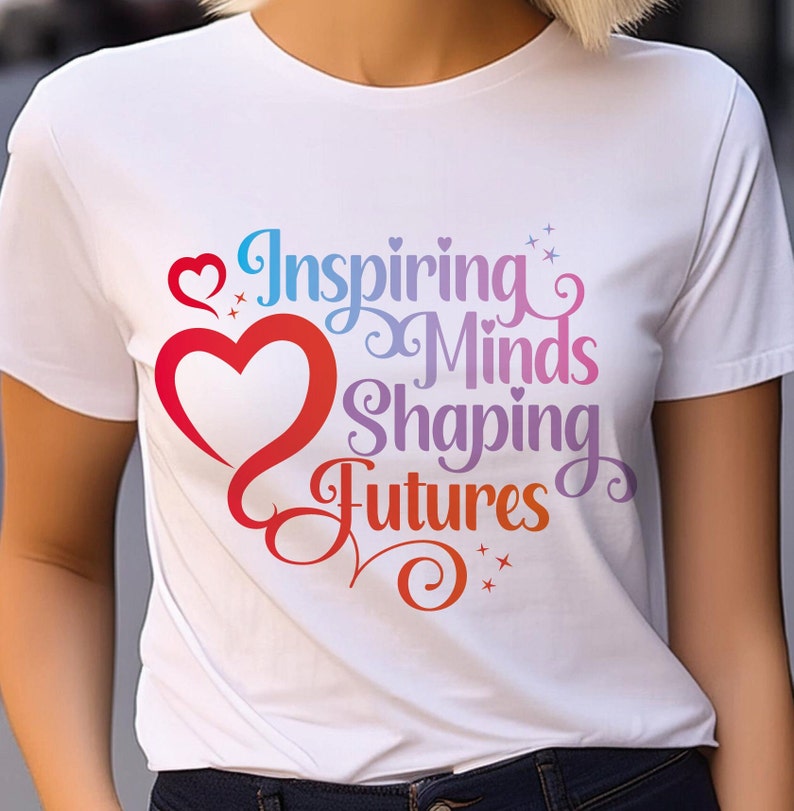 May include: White t-shirt with a rainbow-colored graphic that says "Inspiring Minds Shaping Futures" with a red heart.