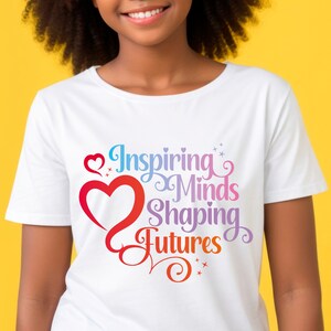 May include: White t-shirt with a rainbow-colored graphic that says "Inspiring Minds Shaping Futures" with a heart design.