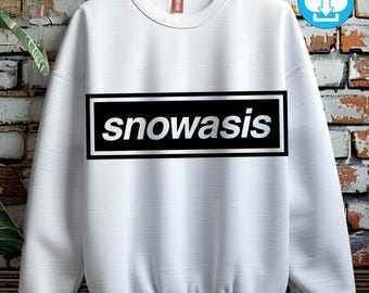 May include: White sweatshirt with the word "snowasis" in a black rectangle with a white border. The text is in a silver, bold font. The sweatshirt has a crew neck and long sleeves. A digital download icon is in the upper right corner.