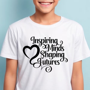 May include: White t-shirt with black text that reads "Inspiring Minds Shaping Futures" with a heart graphic.