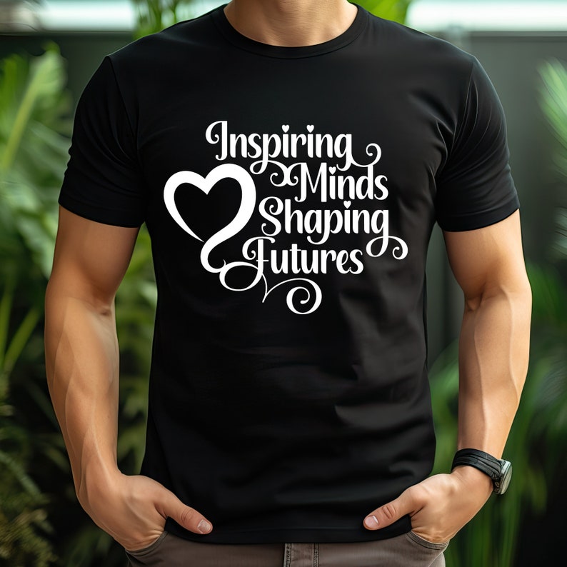 May include: Black t-shirt with a white heart and the text "Inspiring Minds Shaping Futures" in a stylized font.