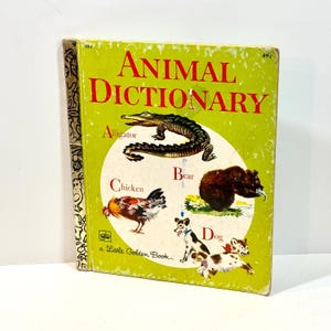 May include: A vintage "Animal Dictionary" book with a green cover and red lettering. Illustrations of an alligator, chicken, bear, and dog are featured. The book is a "Little Golden Book".