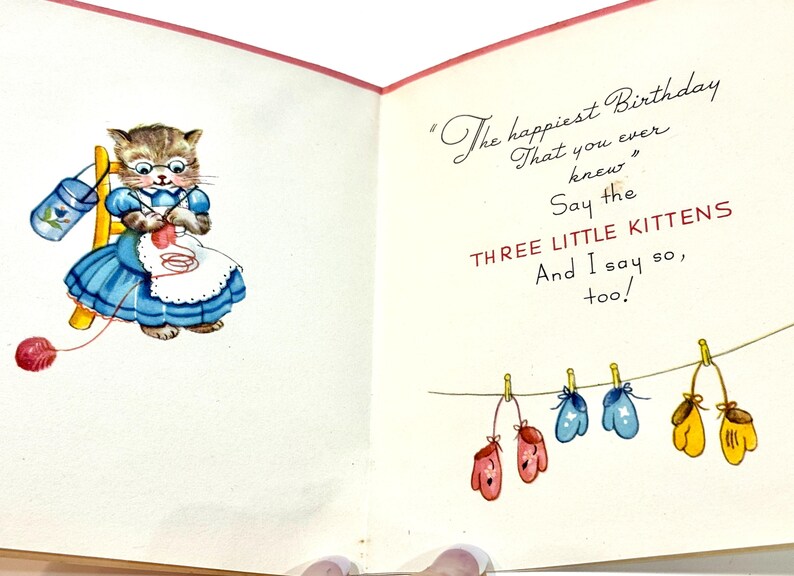 May include: Vintage birthday card featuring a cartoon cat wearing glasses and a blue dress, knitting with red yarn. The card includes the text "The happiest Birthday That you ever knew" and "Say the THREE LITTLE KITTENS".