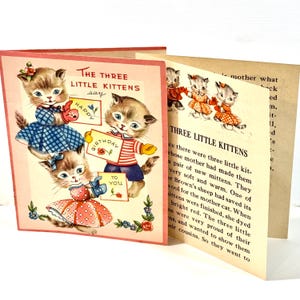 May include: Vintage children's book featuring illustrations of kittens. The cover shows three kittens holding signs that say "Happy Birthday to You." The book's title is "The Three Little Kittens."