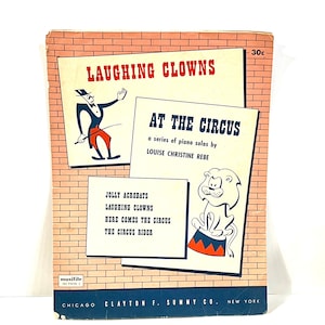 May include: Vintage sheet music cover titled "Laughing Clowns At The Circus." The cover features illustrations of a clown, a lion, and a brick wall background. The text includes the names of the songs and the composer.