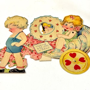 May include: Vintage Valentine's Day card featuring two children and a carriage. The boy wears blue overalls, and the girl is in a green dress. The card includes the text "Making a hit with a Beau."