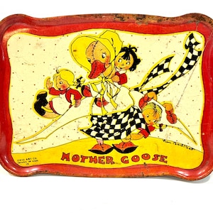 May include: Vintage metal tray with a red border and a Mother Goose illustration. The tray features a yellow background with a cartoon goose and children, with the words "Mother Goose" printed in red.