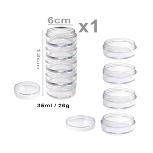 May include: A set of six clear plastic containers with lids. The containers are stacked in a tower, with the top container measuring 6 cm in diameter and 13 cm in height. The containers are labelled "35ml / 26g".