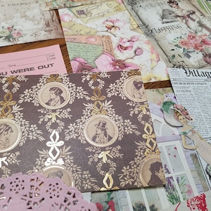 May include: A brown patterned paper with gold accents featuring a repeating design of oval frames with portraits of people. The paper has a vintage aesthetic and is perfect for scrapbooking or crafting.