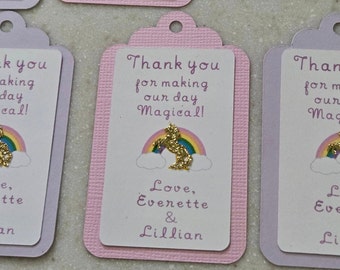 May include: Pink and purple thank you tags with a gold glitter unicorn and rainbow design. The text reads "Thank you for making our day Magical! Love, Everette & Lillian".