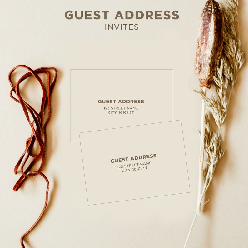 May include: Two white cards with brown text that reads "GUEST ADDRESS" followed by an address. The cards are on a beige background with a brown leather cord and a dried flower stalk.