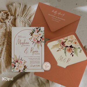 A terracotta boho wedding invitation with matching burnt orangeenvelopes, envelope liner, wax seal and address printing