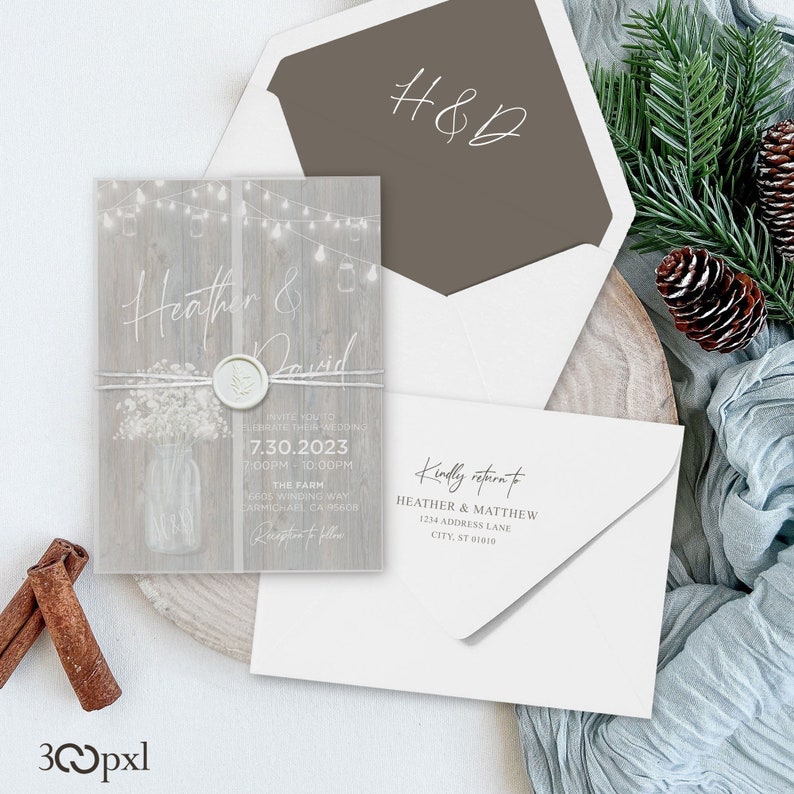 A rustic wedding invitation with matching envelope liner, vellum jacket, wax seal and twine