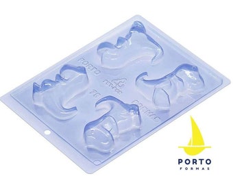 May include: Clear plastic mold with four dinosaur shapes. The mold is labeled "Porto Formas" and has a sailboat logo.