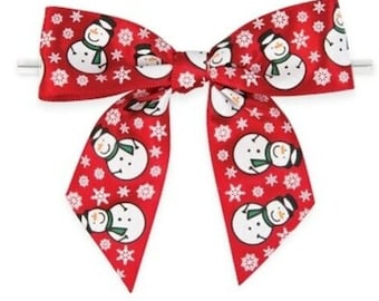 May include: Red bow with a snowman pattern. The bow is tied with a white ribbon and has a white snowflake pattern.