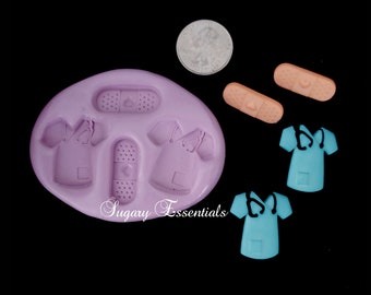 May include: Silicone mold for making fondant or gum paste decorations. The mold features two doctor's scrubs, a bandage, and a larger bandage. The mold is purple and the decorations are pink and blue.